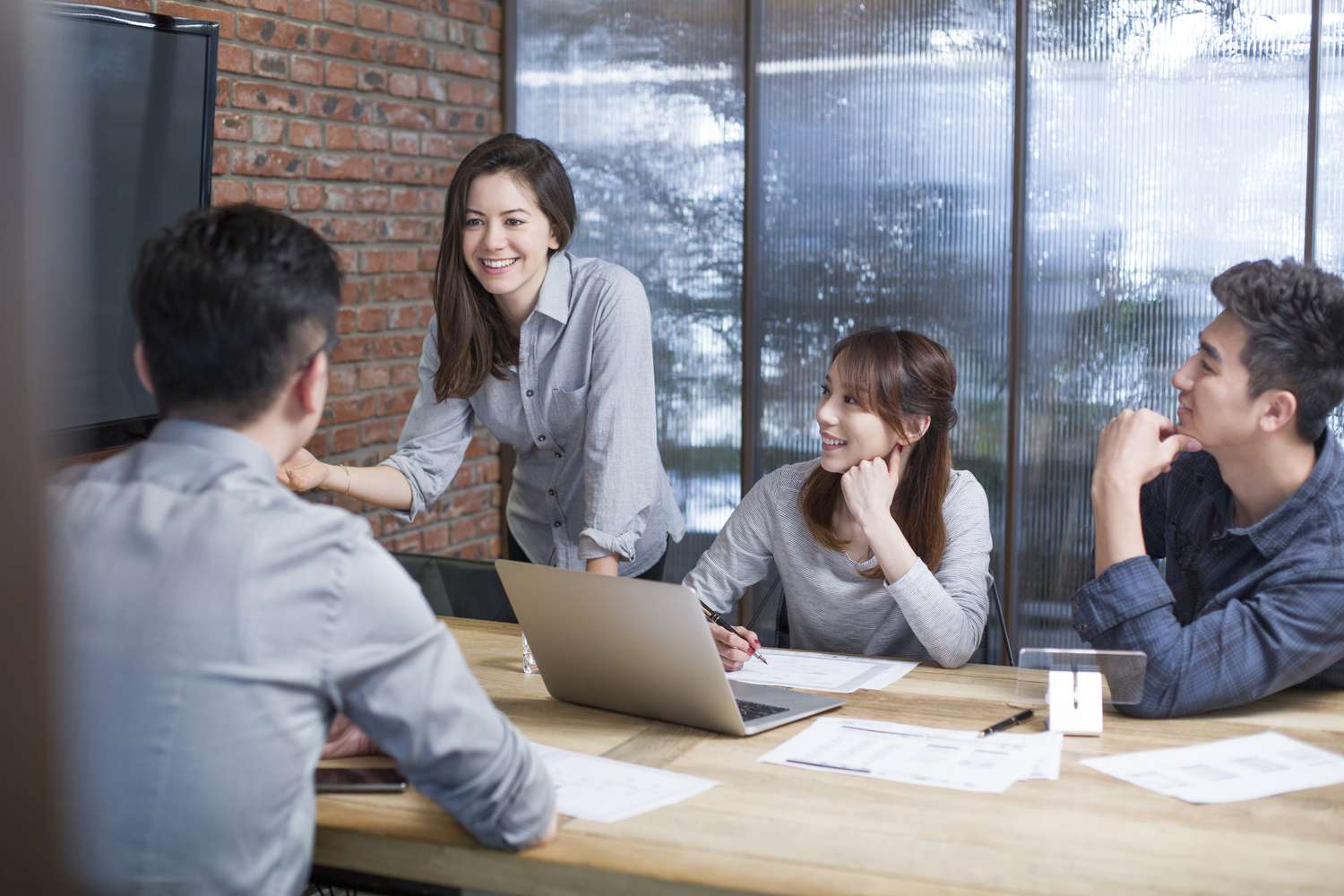 A professional meeting in a human resources office with an HR representative and an employee discussing career options across a desk